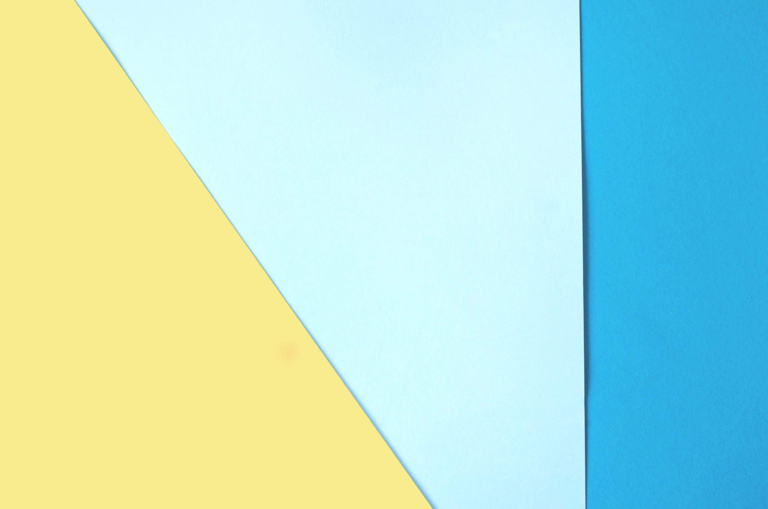 Aplats de couleurs géométriques jaune, bleu clair et bleu foncé.